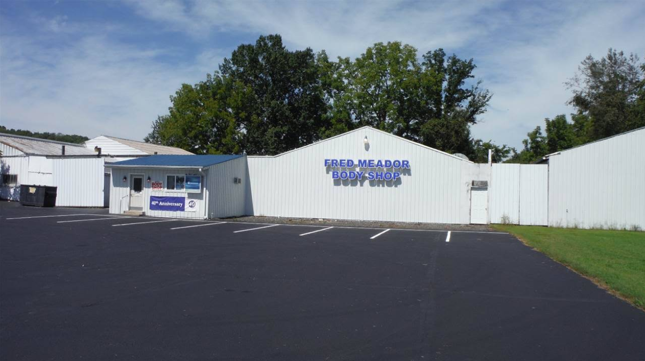 Car repair shop in sunny setting