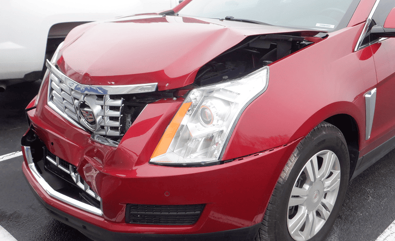 Damaged red SUV in parking lot