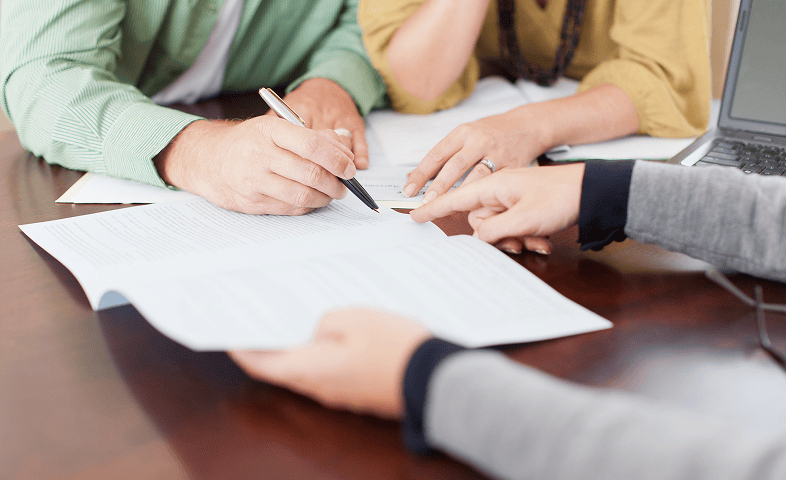 People reviewing documents at a table