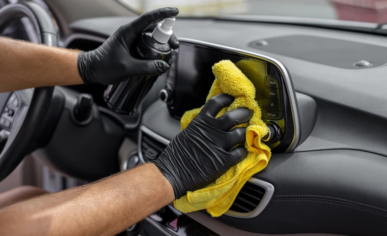Car interior being cleaned with spray